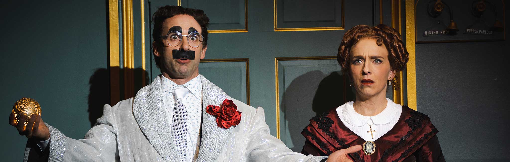 A man looking surprised and a woman frowning toward the camera.