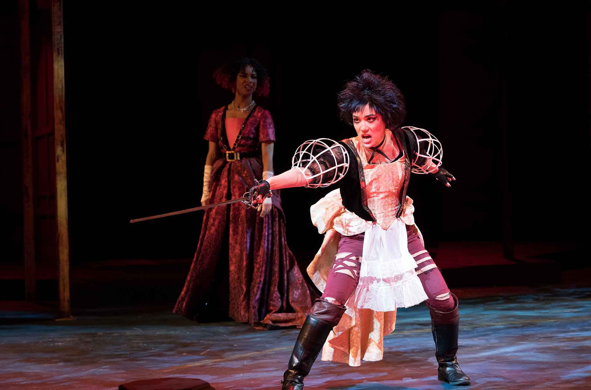 A person standing poised with a sword. 