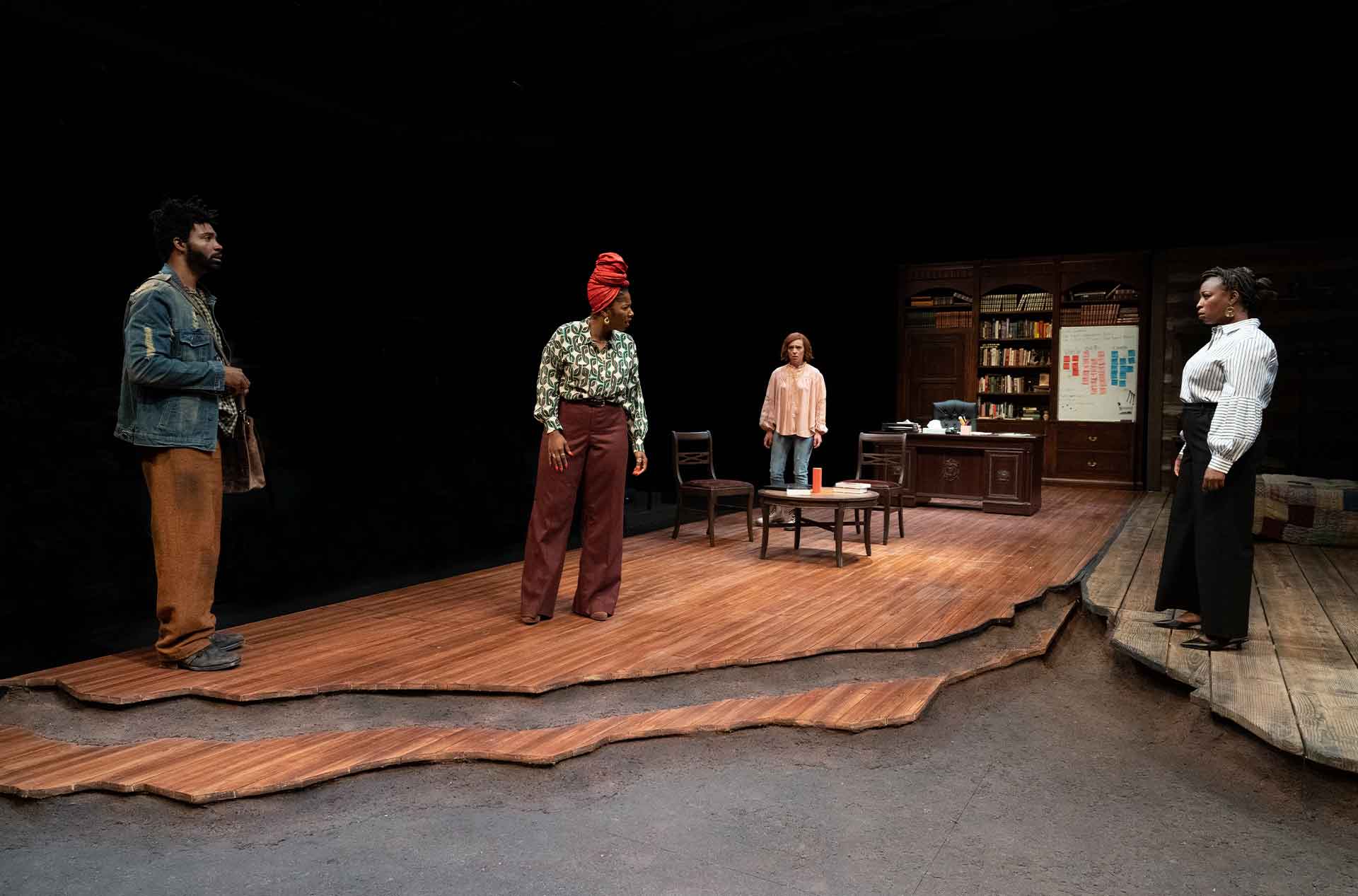 Four people standing looking at each other.