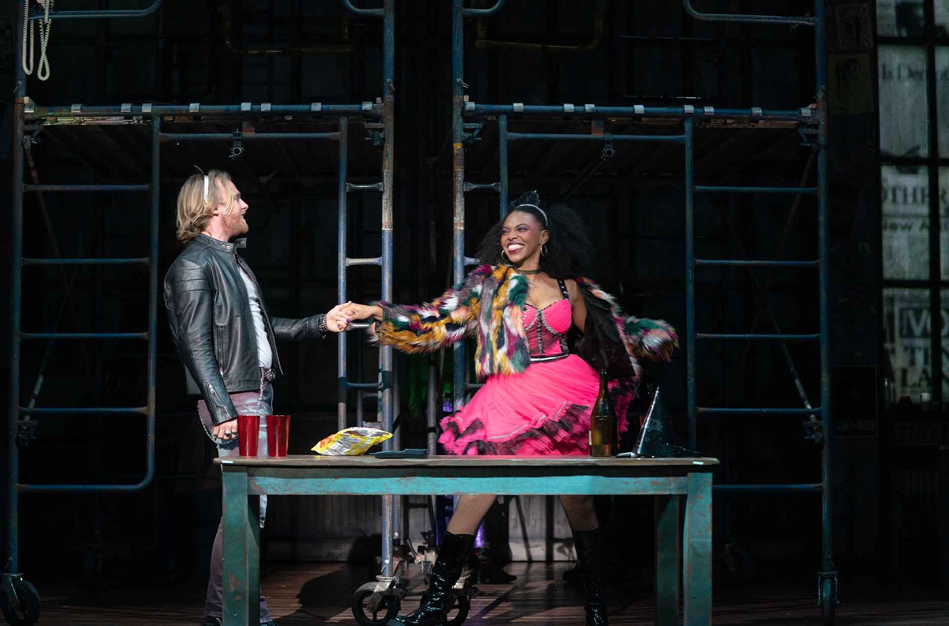 Two people holding hands looking at each other.