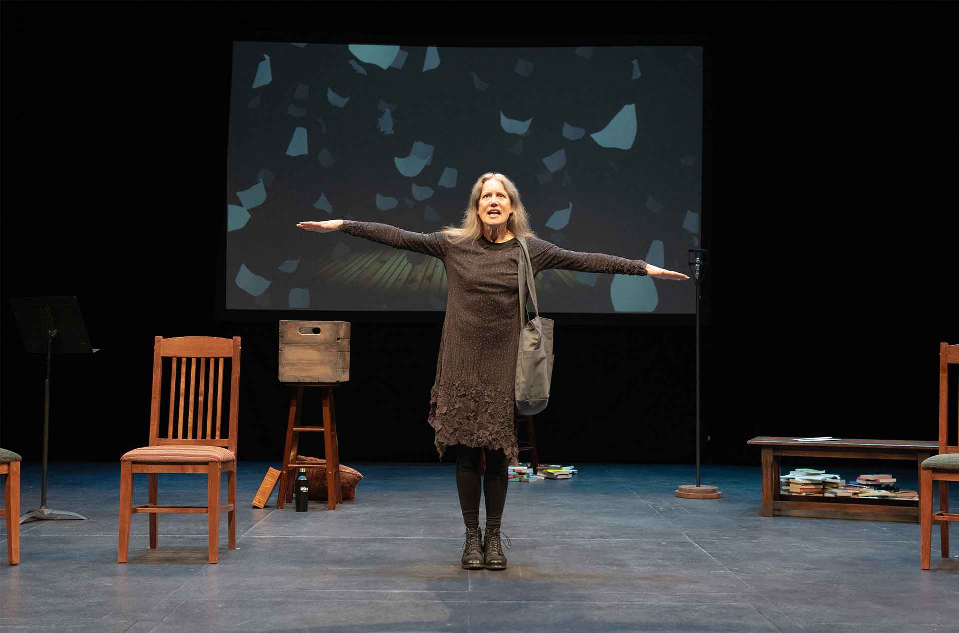 A woman with her arms out like she is flying. 