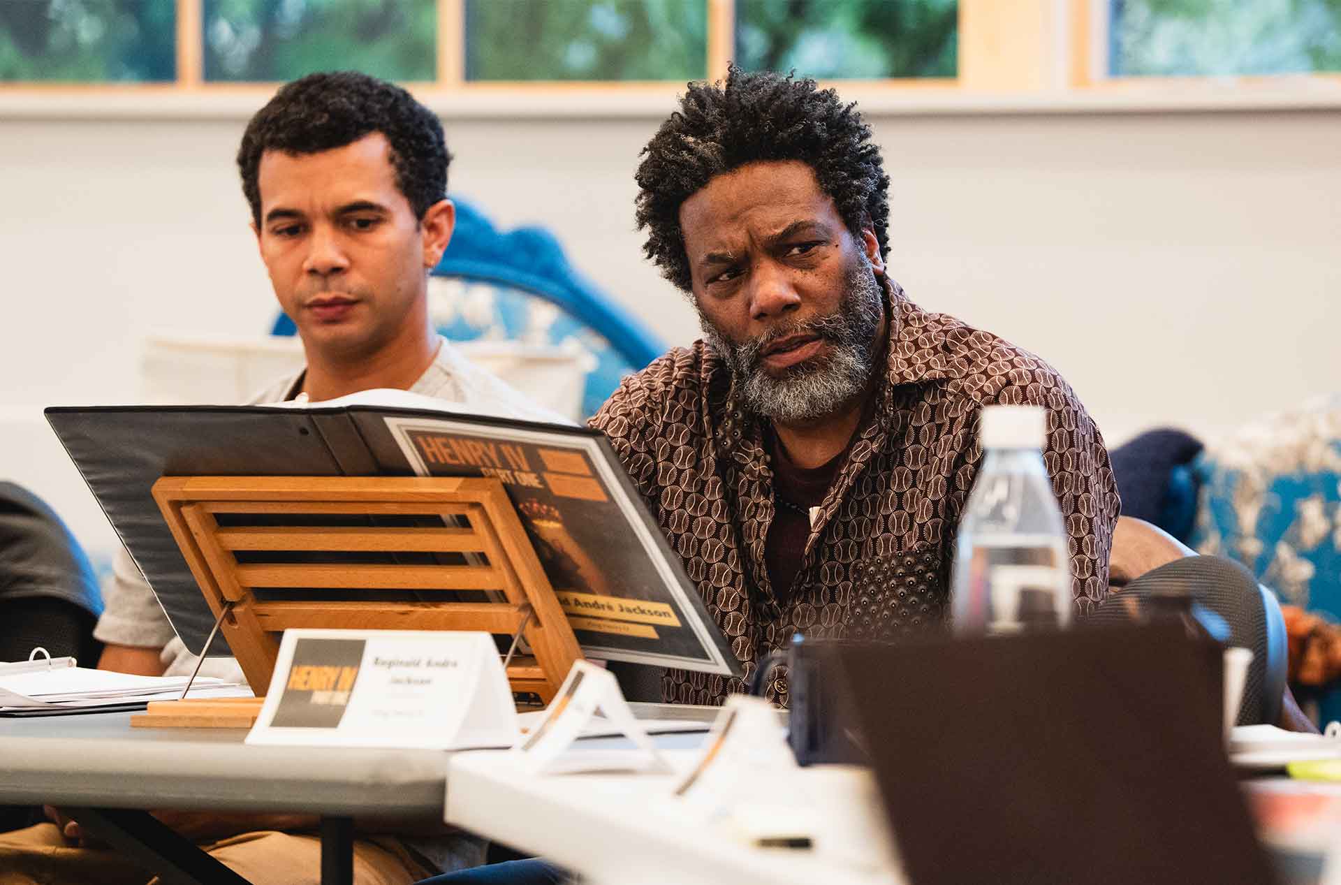 Two people reviewing a script together during a group session.