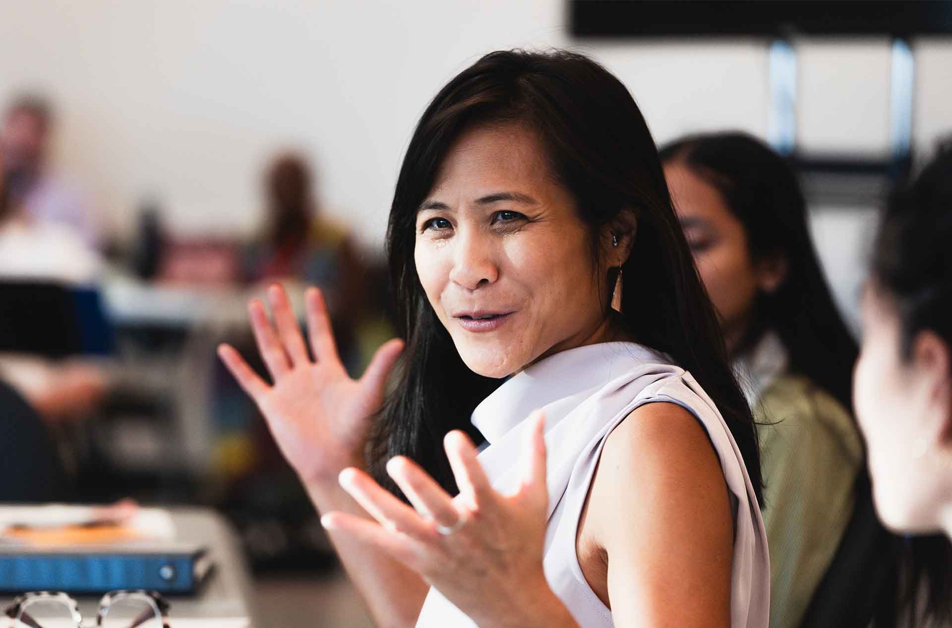 Creative team member gestures while speaking during a table rehearsal.