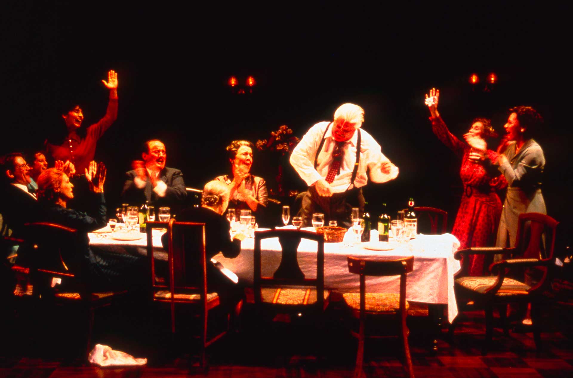 Group of people standing around a table.