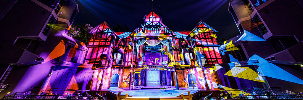 The Allen Elizabethan stage with a kaleidoscope of lights shining on it.