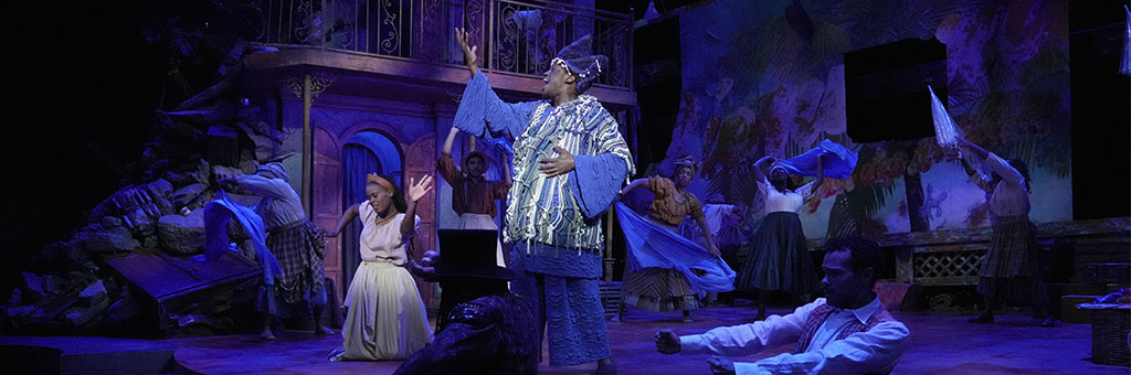 A person singing and gesturing toward the sky.