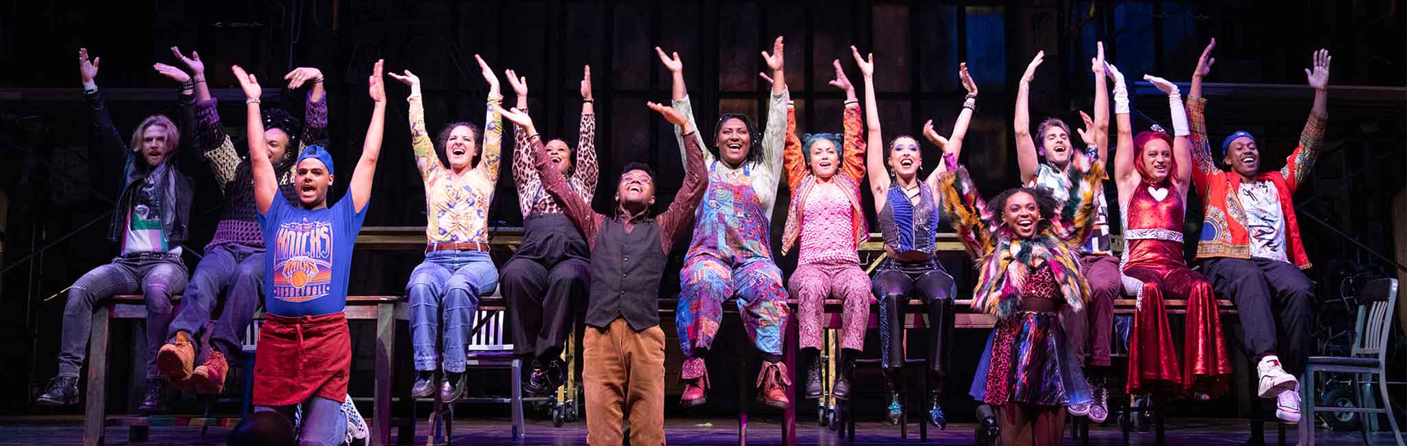 A group of people with their hands in the air.