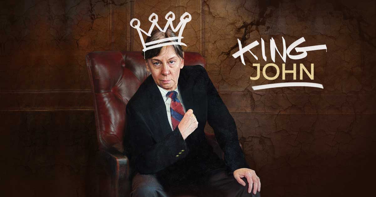 Actress Kate Wisniewski dressed in a suit sitting in a leather chair.